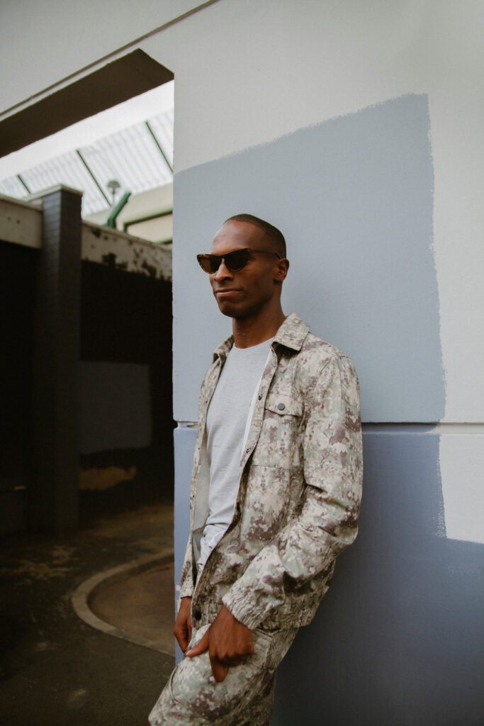 Portrait of young autistic black man wearing sunglasses and trendy outfit